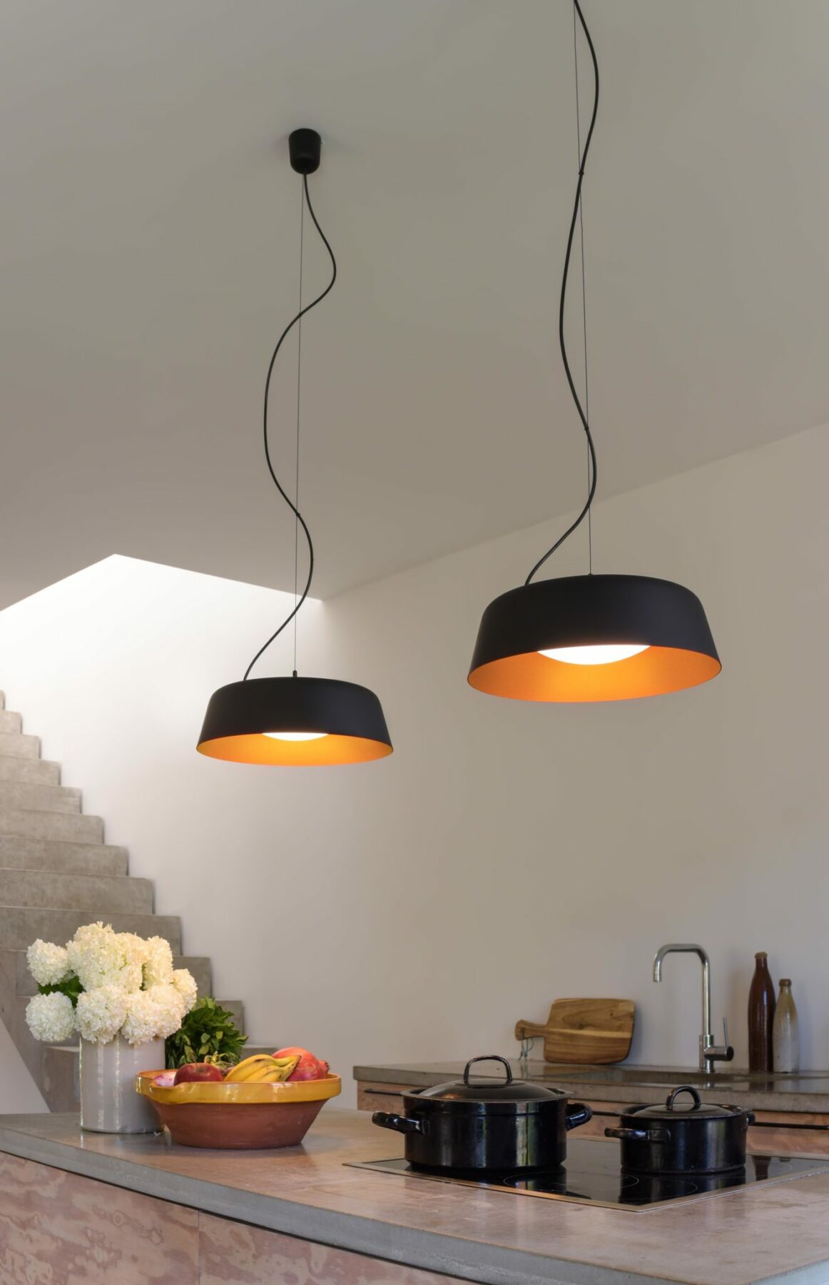 Bowl LED pendant luminaires in bi-colour over a modern kitchen counter.