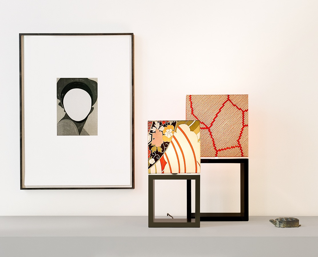 Two GATE SAISO table lamps next to a painting on a light grey sideboard.