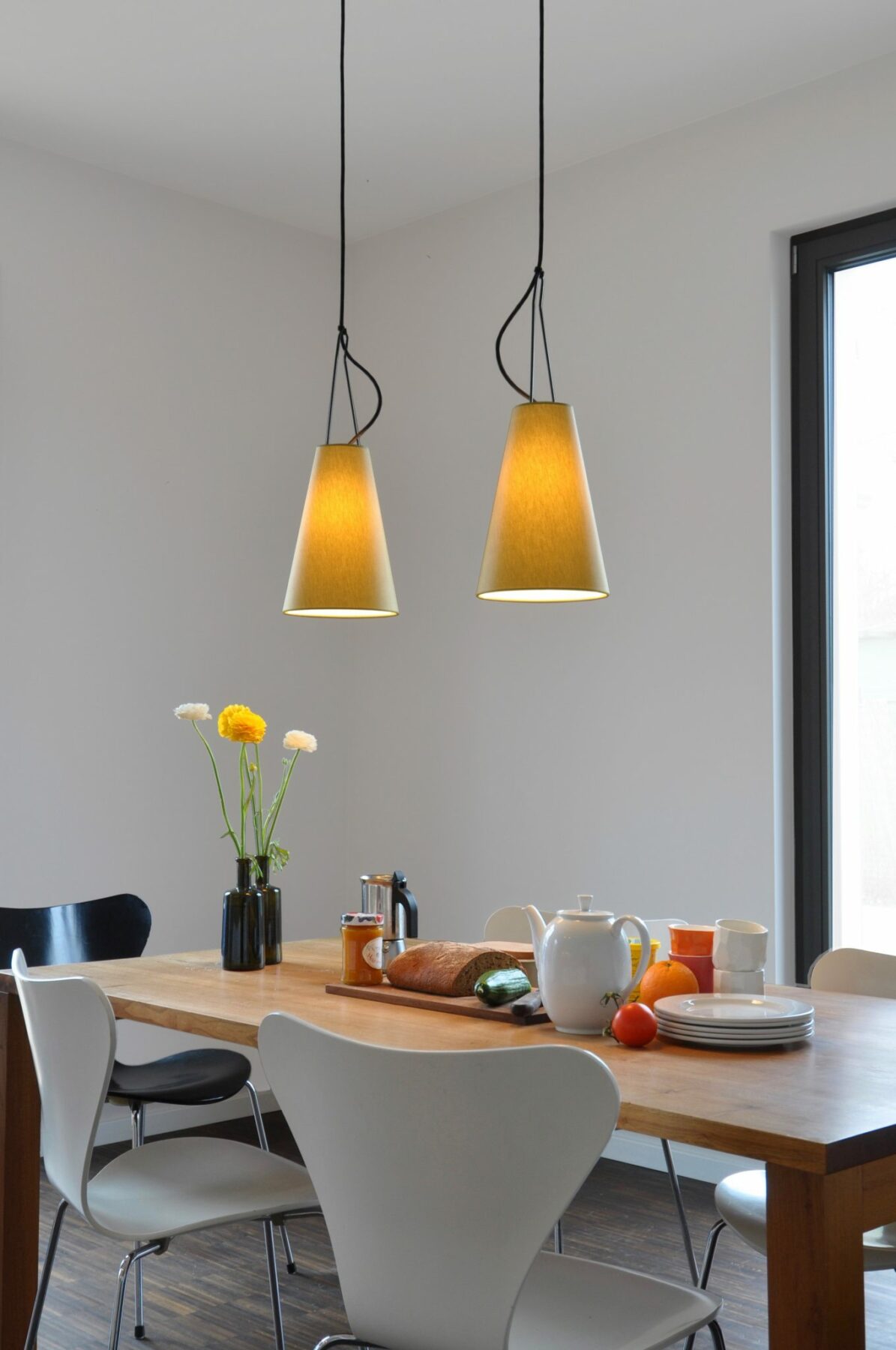 Two MIA pendant lights above a breakfast table.