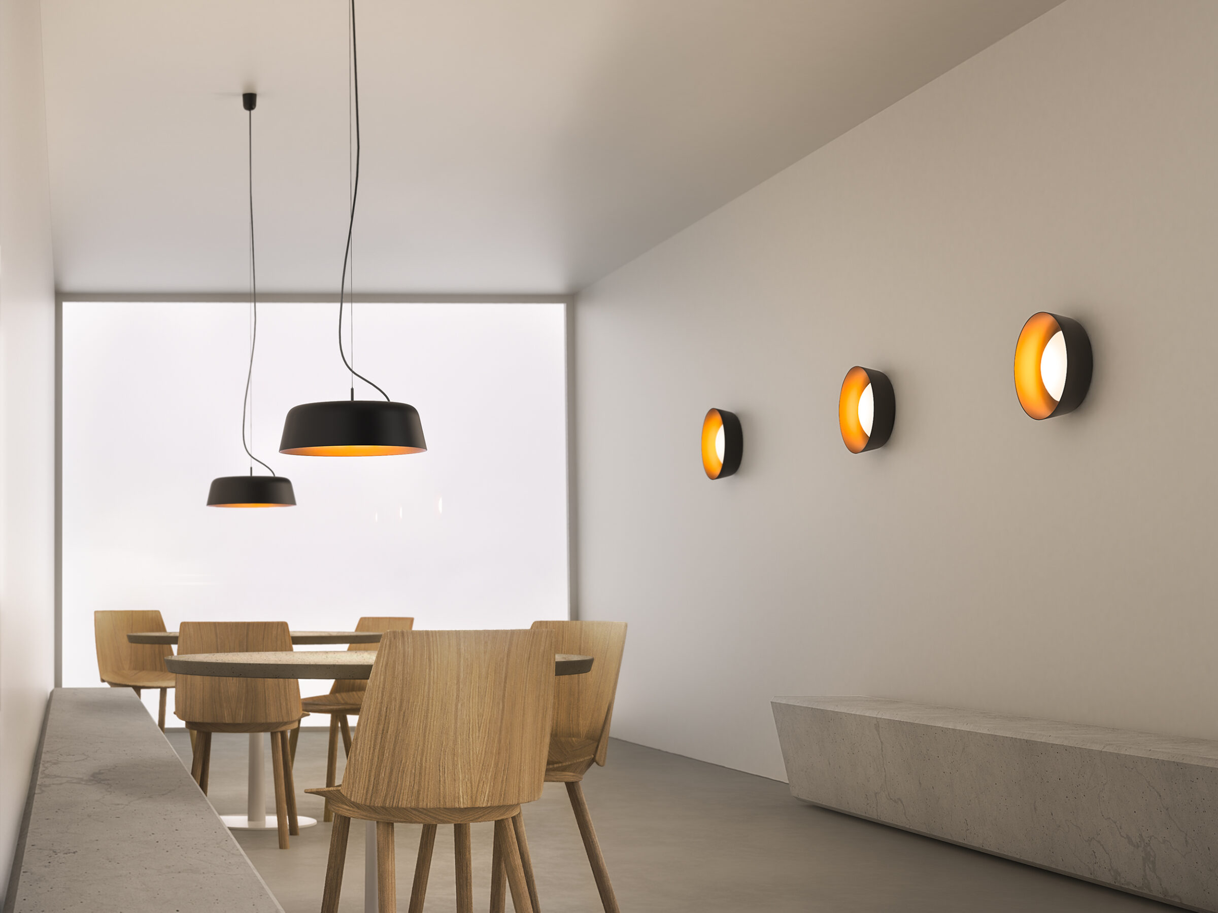 Bowl pendant lamps and wall lamps in a modern café interior