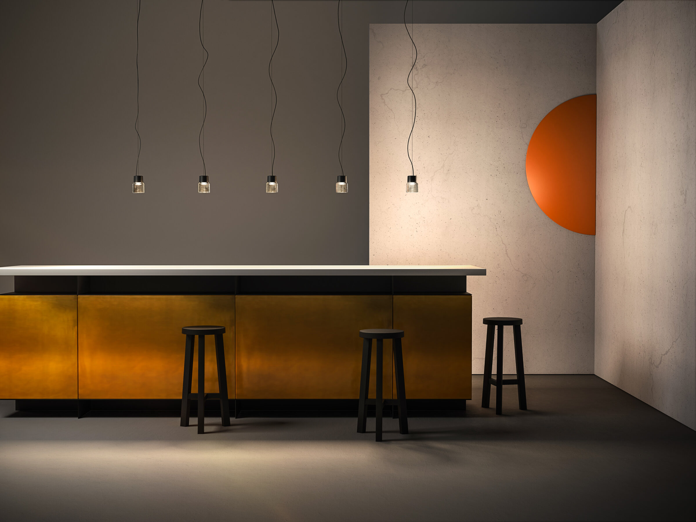 Cast LED pendant luminaire in cast glass and anodised aluminium hung in a row above a modern bar.