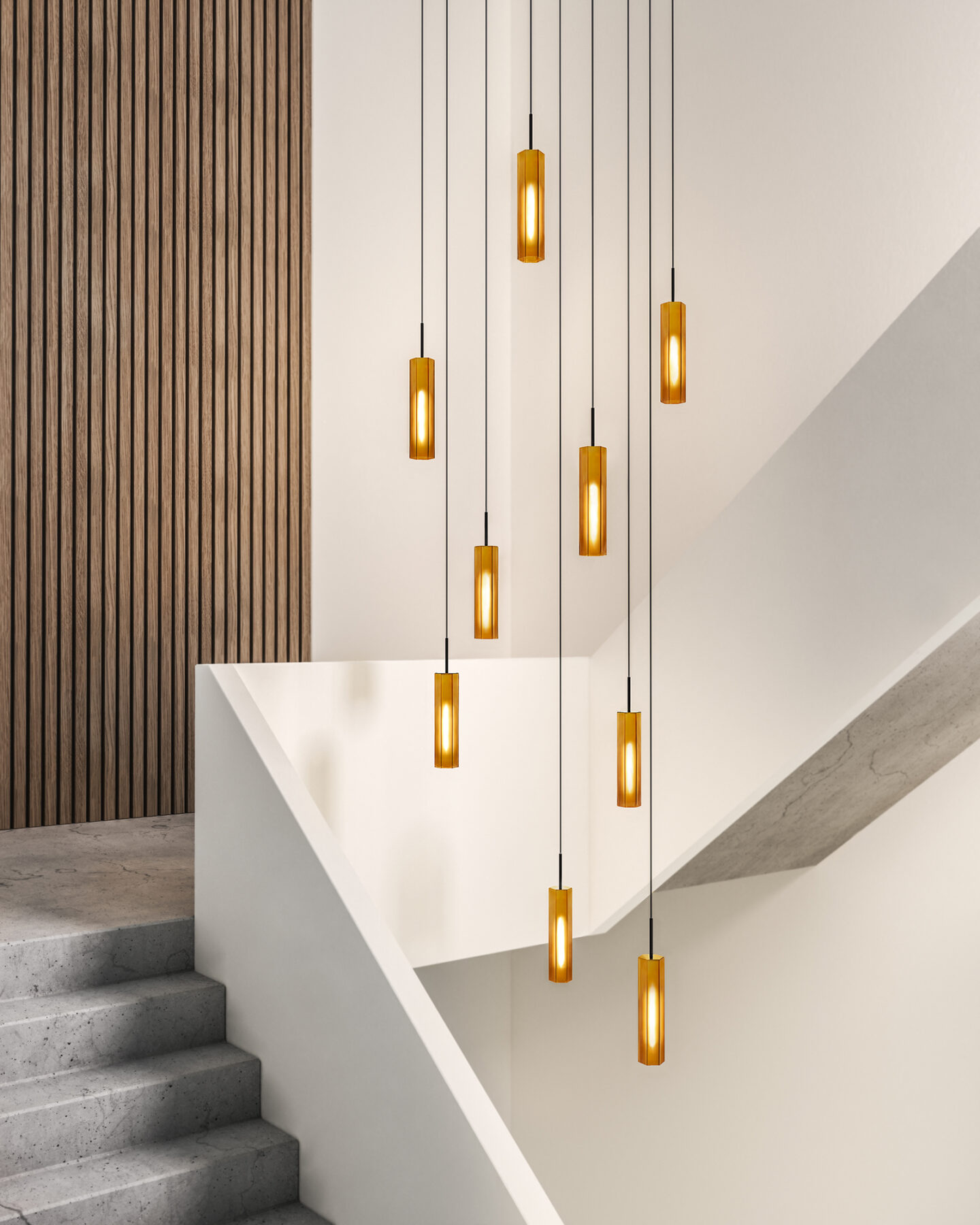Ensemble of several honey-colored glass lights in a modern stairwell