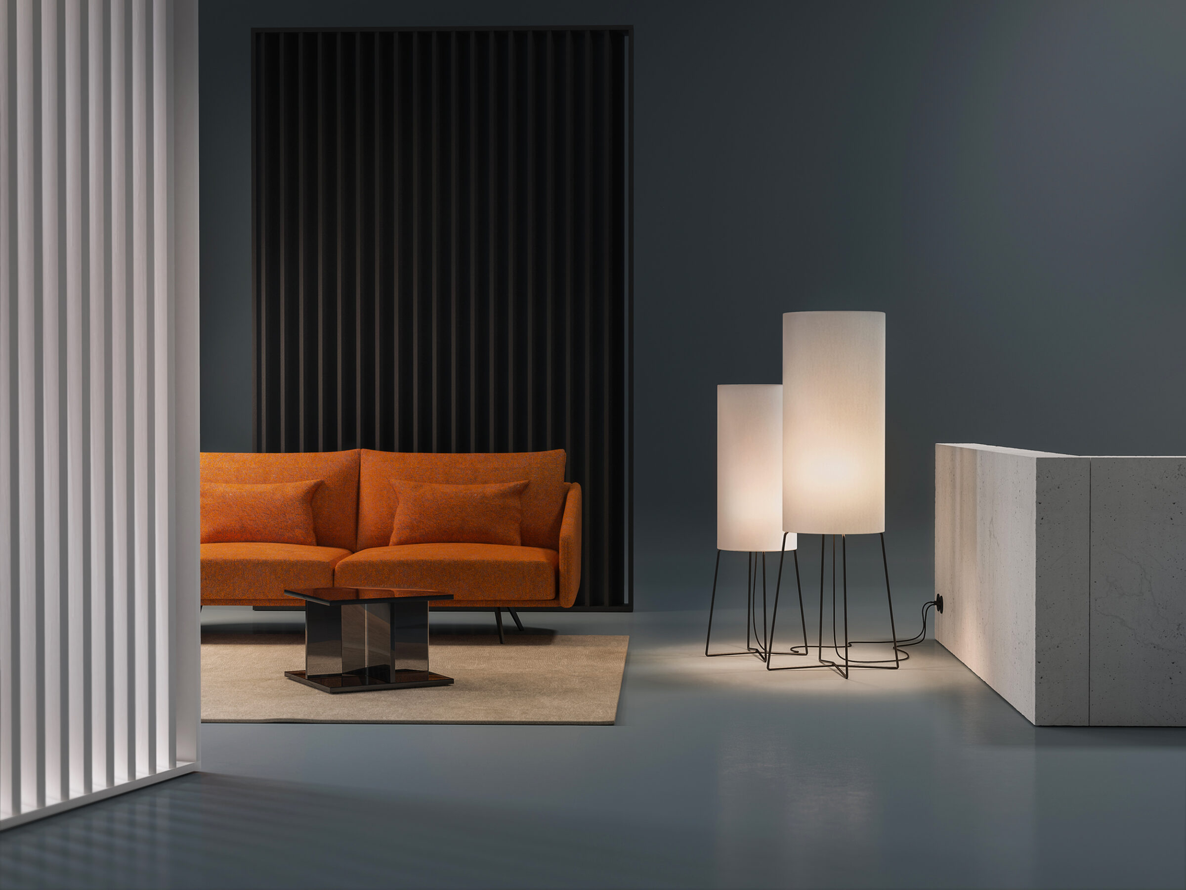 Two sizes of the CYLS COLUMN floor lamp in a modern lounge.