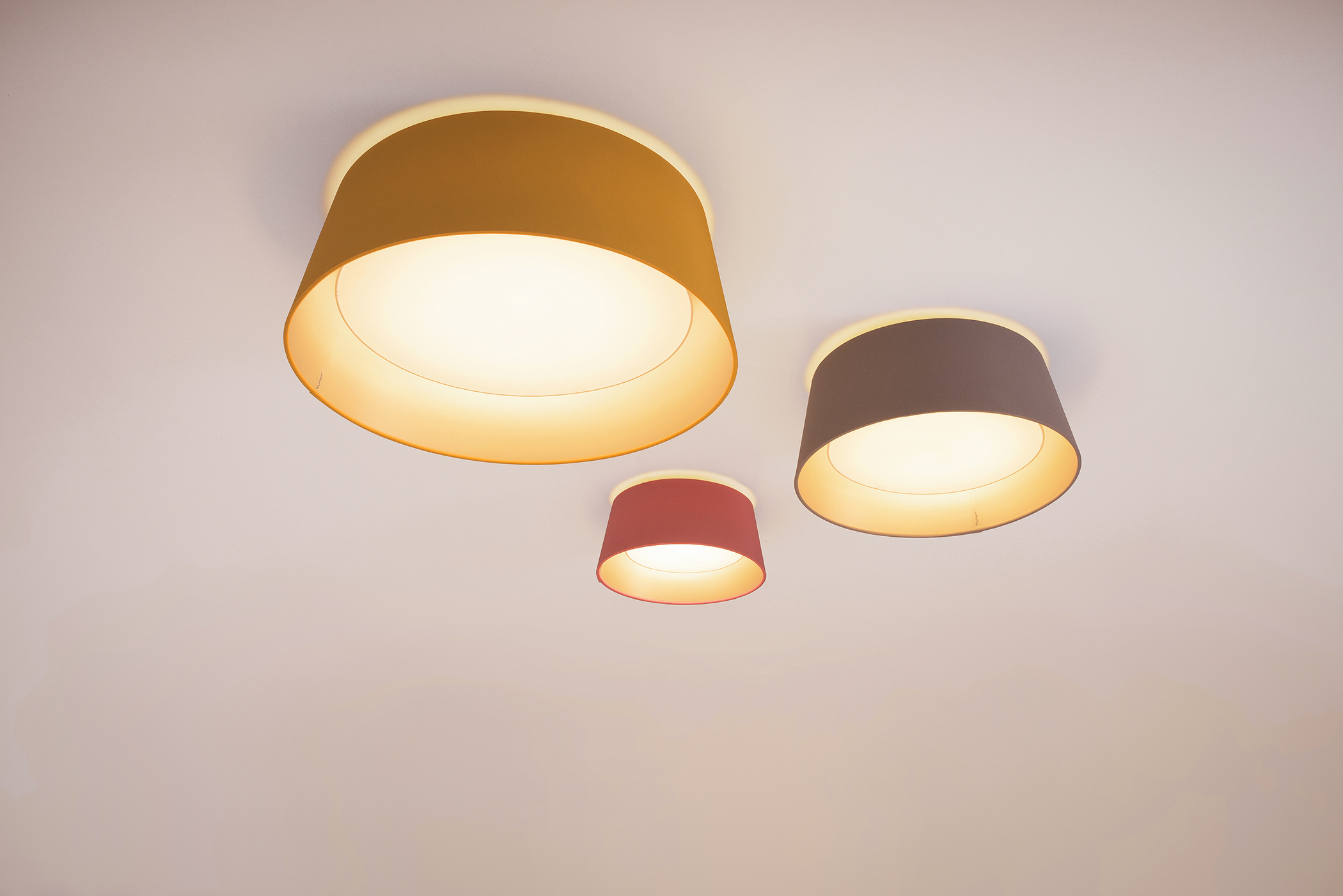 Set of three LEA M ceiling lamps in three sizes and colours.